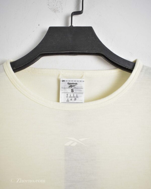 تاپ ورزشی کرم زنانه Reebok
